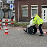 Medewerker gemeente Weert helpt slechtziende voorbijganger bij wegafzetting